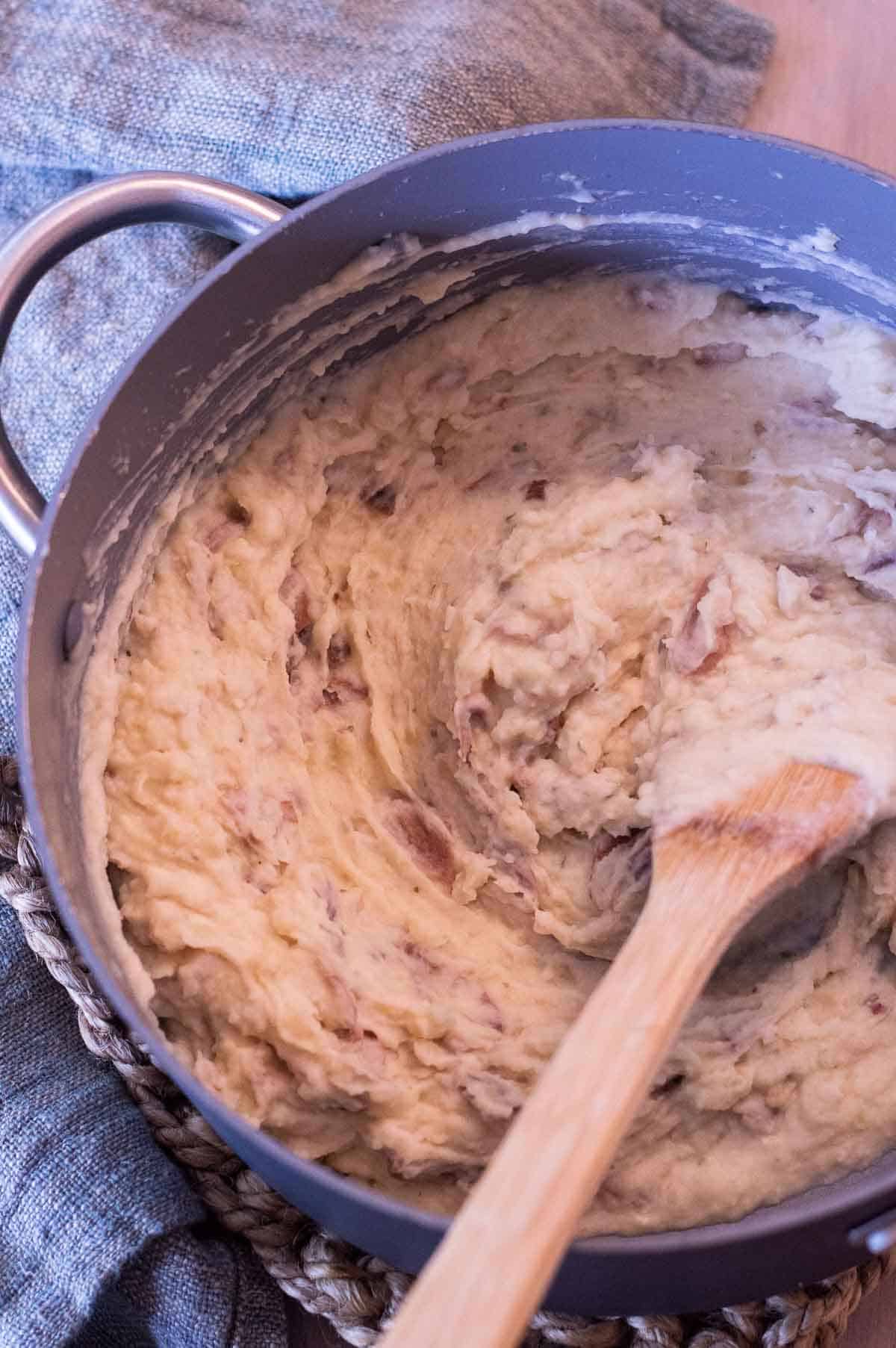 Boursin Mashed Potatoes in a pot being stirred