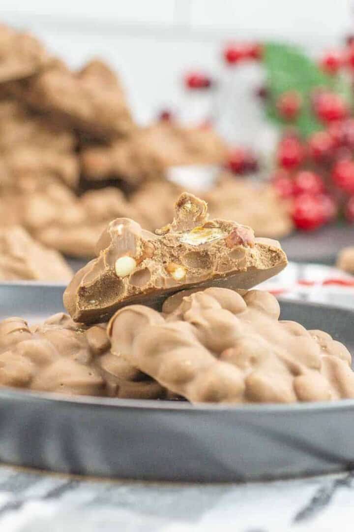 crockpot candy on a plate with a bite take out of it and peanuts showing