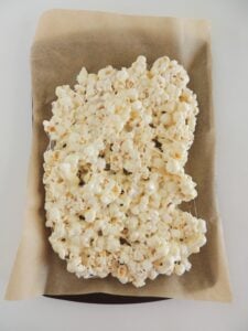 Christmas popcorn step by step instructions popcorn on a parchment lined baking sheet