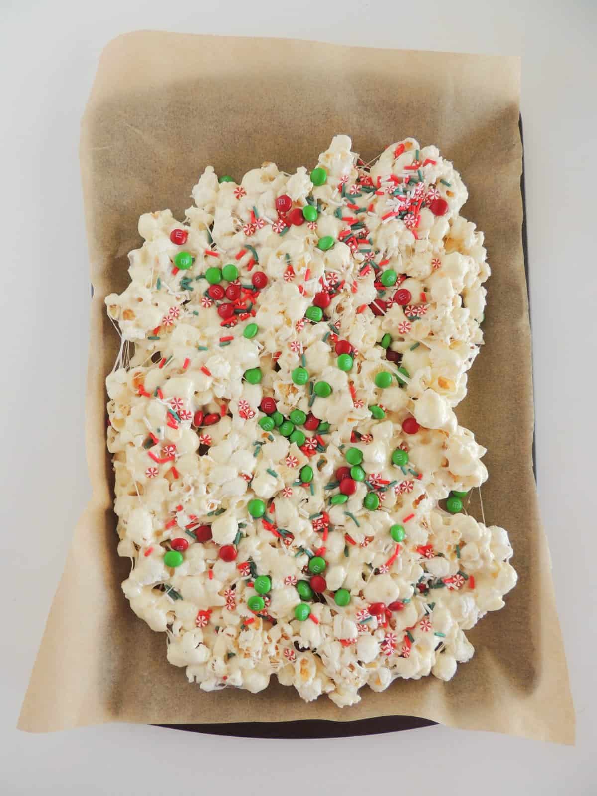 Christmas popcorn step by step instructions popcorn on a parchment lined baking sheet
