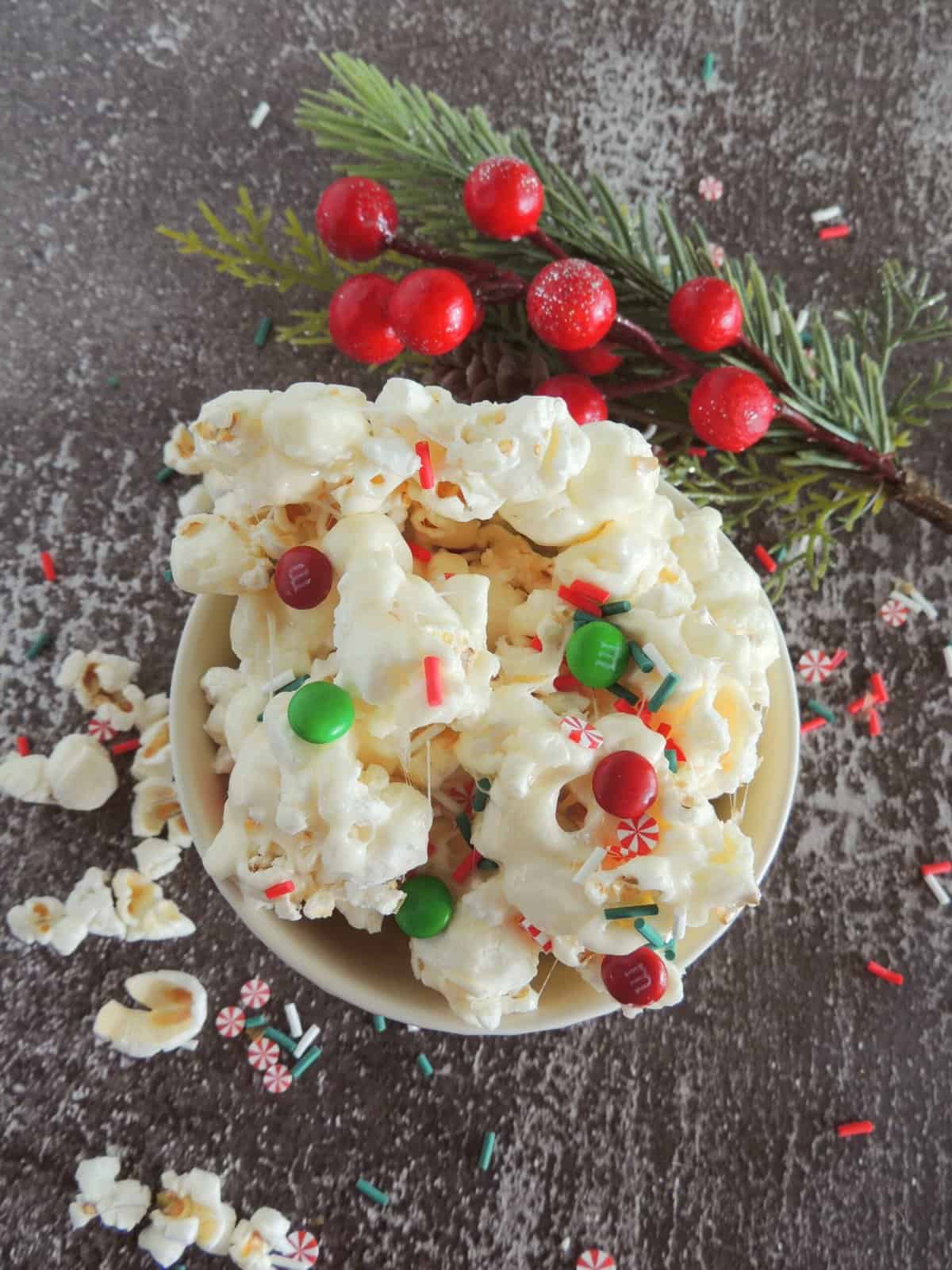 Christmas popcorn in a bowl with red and green M&M's