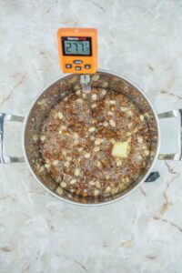 Gluten Free Peanut Brittle ingredients in a pot with candy thermometer