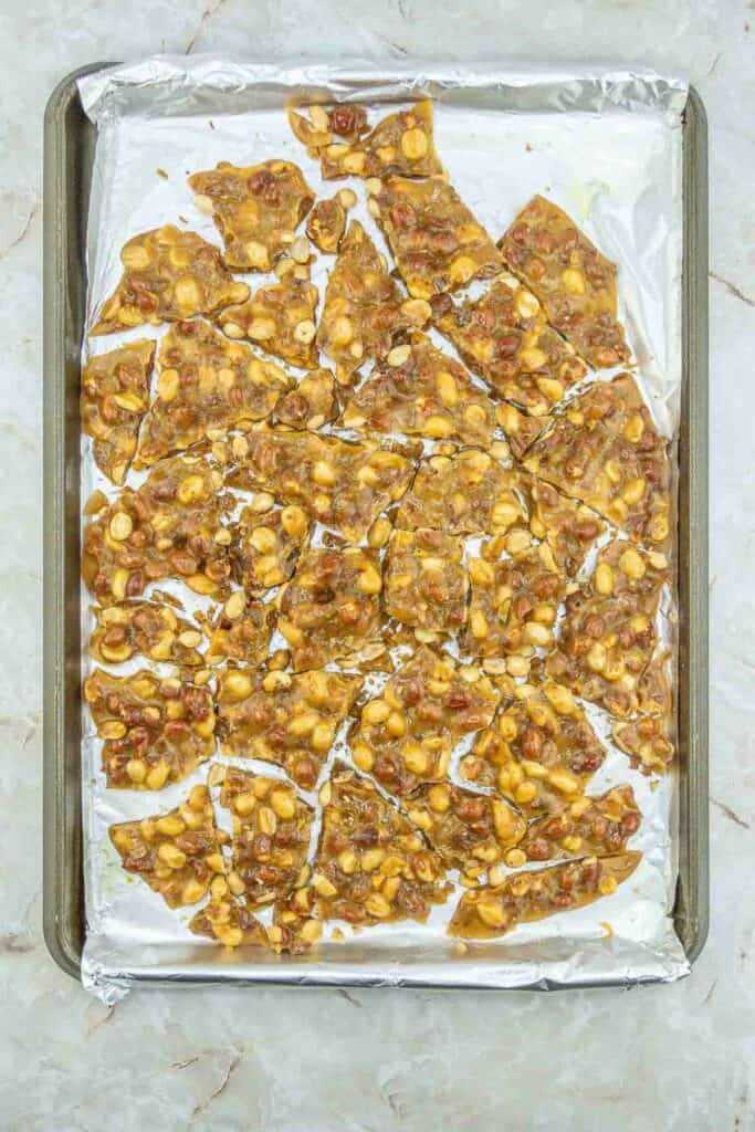 Gluten Free Peanut Brittle cracked on a baking sheet
