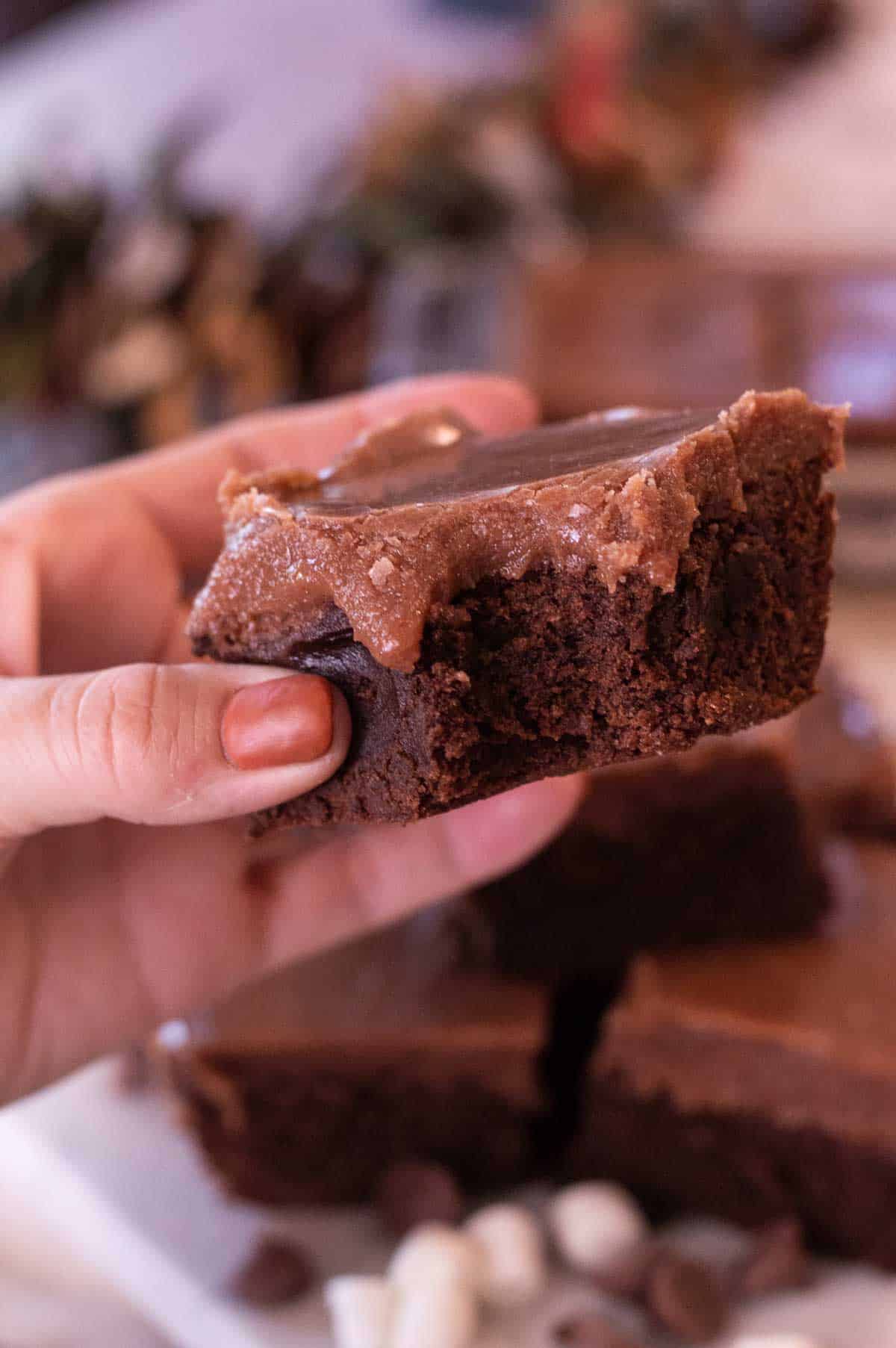 Lunch Lady Brownies in a persons hand with a bite taken out