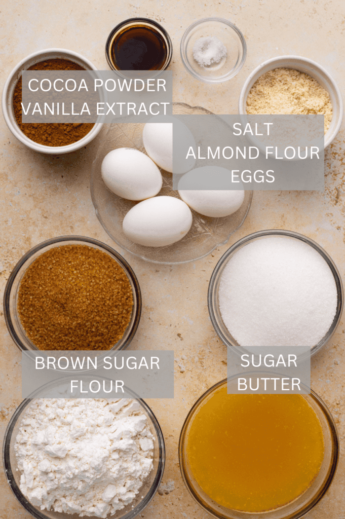 ingredients for gluten free brownies in small glass bowls on a brown countertop