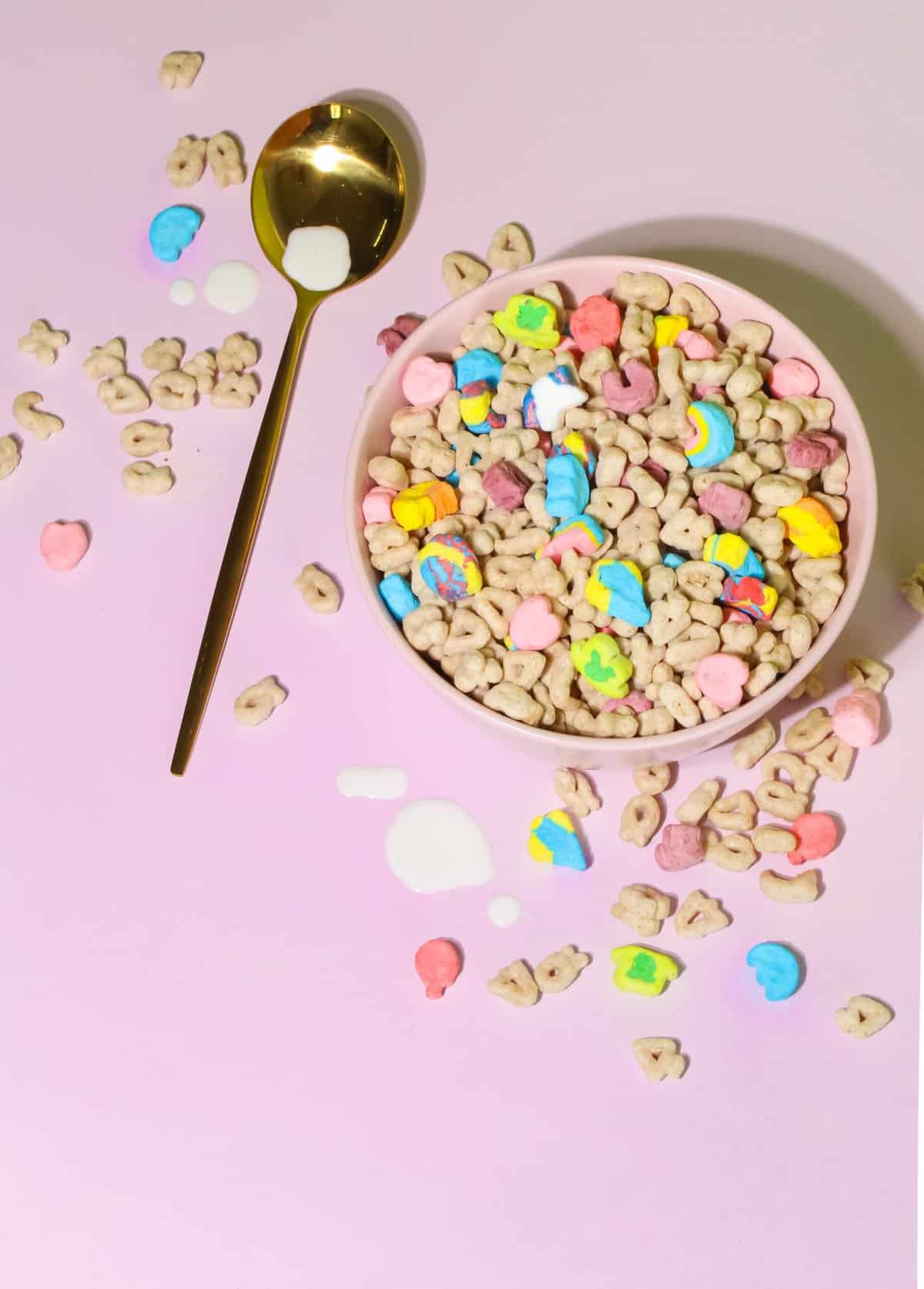 Gluten Free Cereal lucky charms in a bowl with pink background