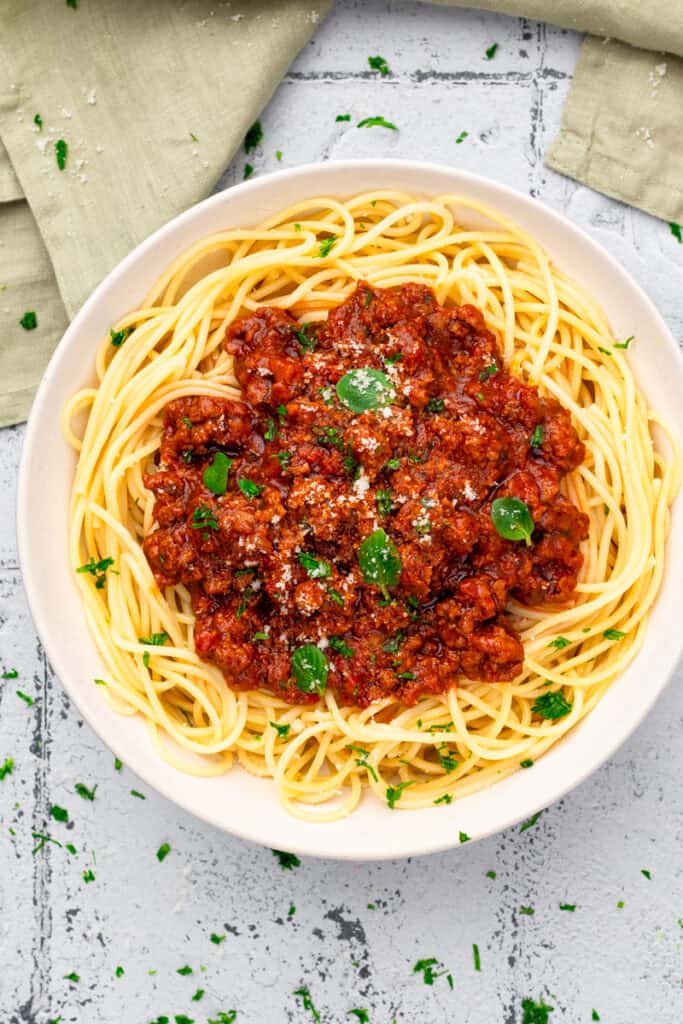 top down image of gluten free noodles in a bowl with red sauce on top