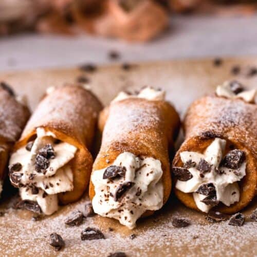 Gluten free cannoli filled with cream and sprinkled with chocolate