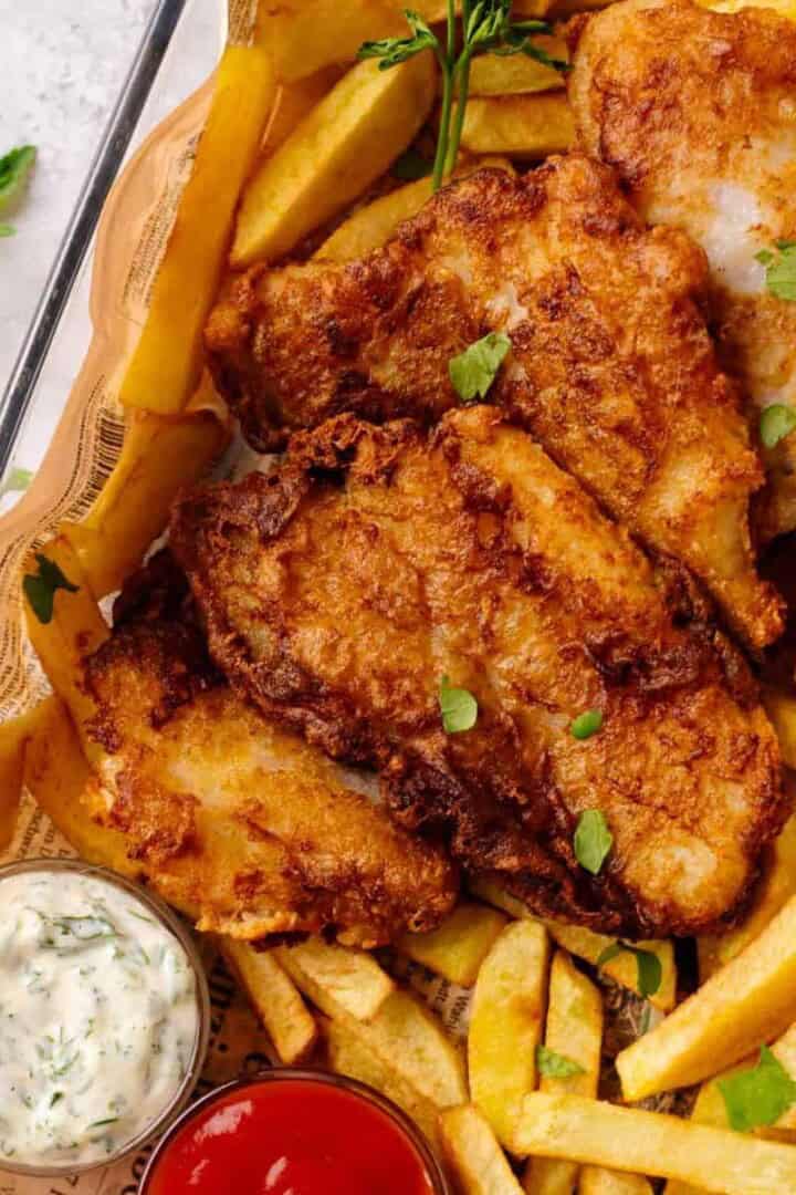 Gluten free fish and chips on a tray with ketchup and tartar sauce