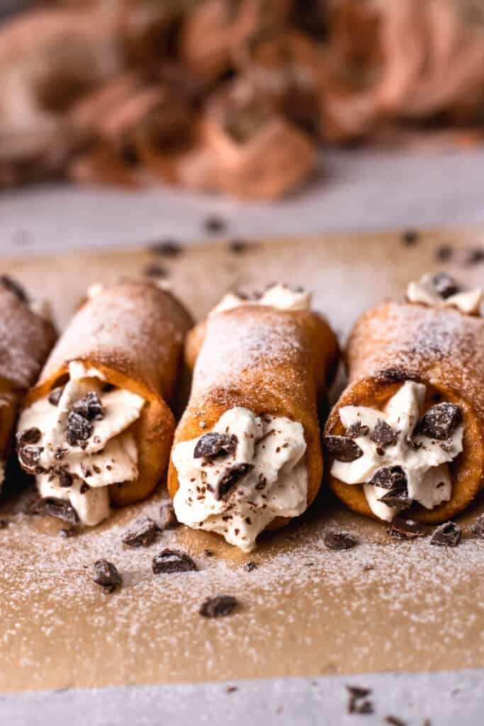 Gluten free cannoli filled with cream and sprinkled with chocolate