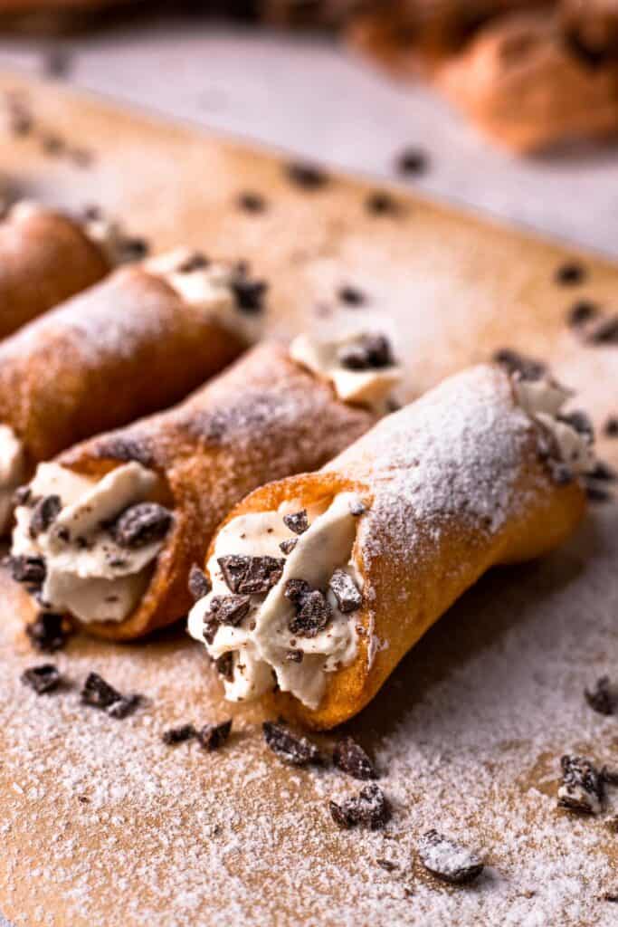 Gluten free cannoli filled with cream and sprinkled with chocolate