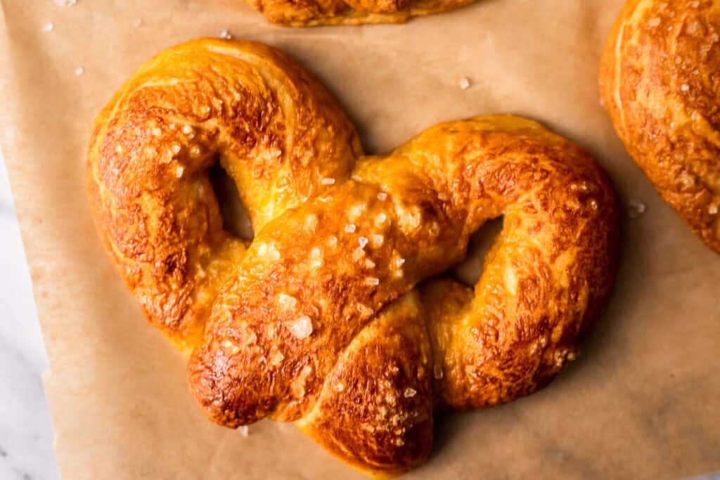 Gluten Free Soft Pretzels on brown parchment paper  rectangle image 
