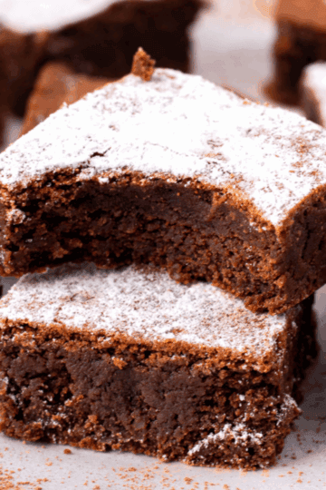 Side view image of two gluten free and dairy free brownies stacked on top of each other