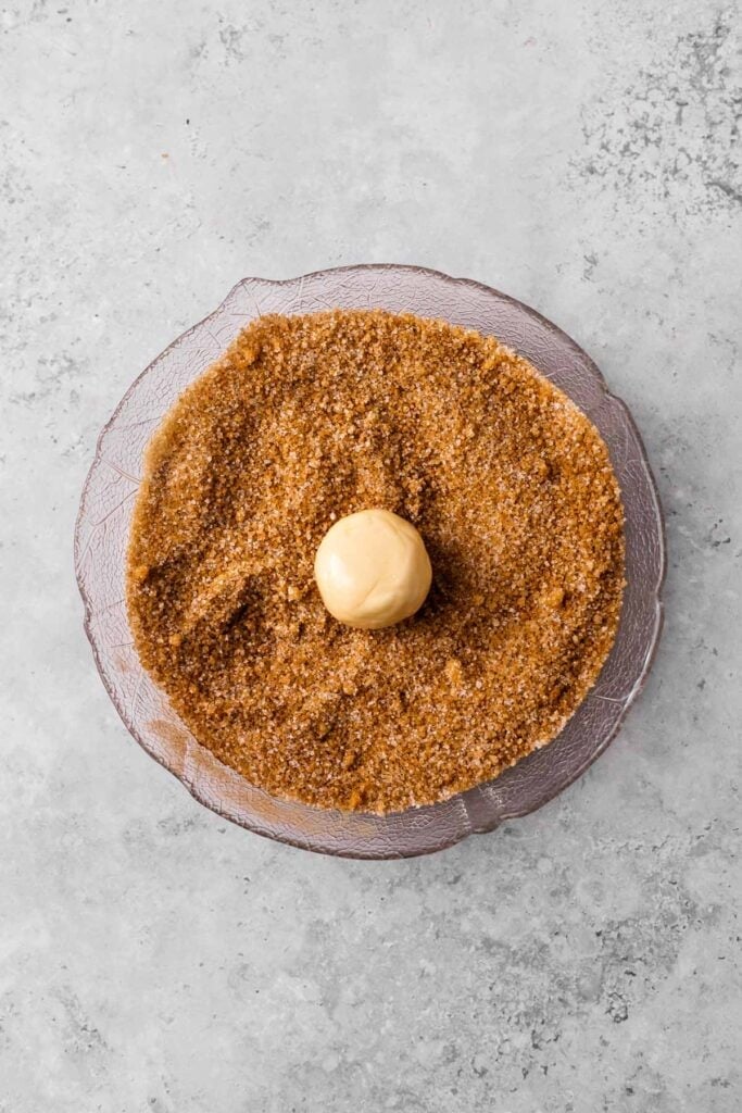Soft Gluten Free Monkey Bread dough ball in sugar mix