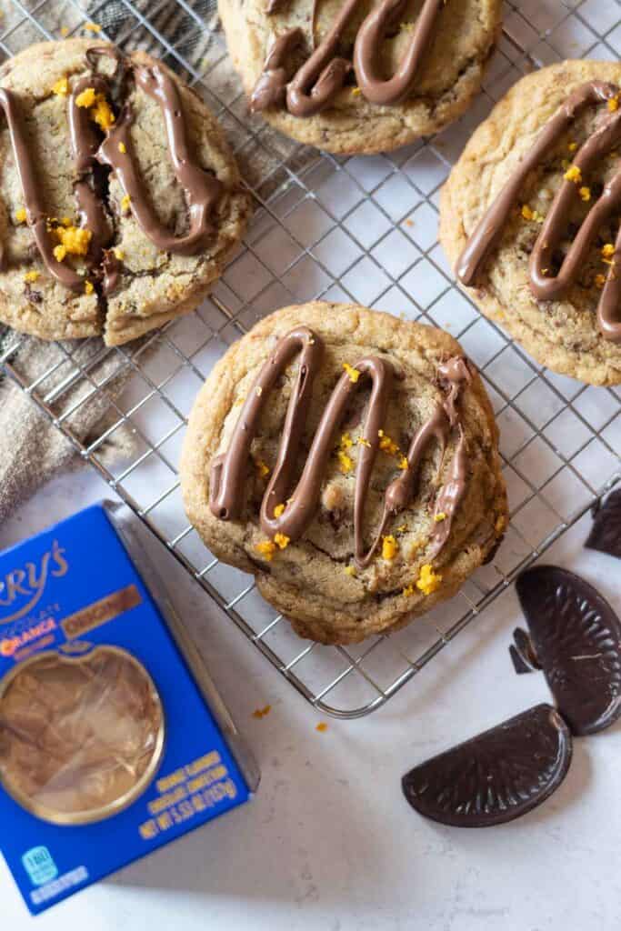 Terry's chocolate orange cookies on a wire rack with orange zest
