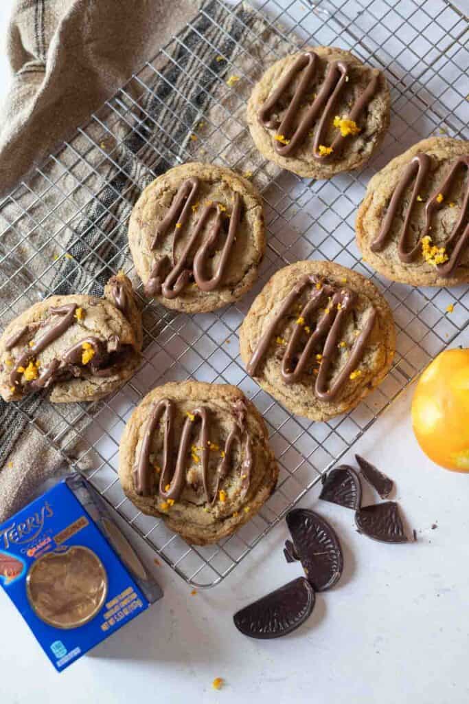 Terry's chocolate orange cookies on a wire rack with orange zest