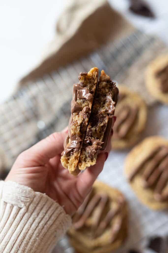 Terry's chocolate orange cookies broken in half in a hand