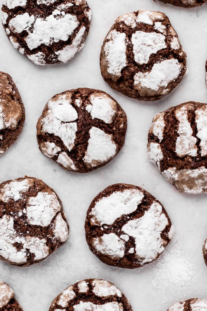 Gluten free chocolate crinkle cookies on a plate in a circle from a top view