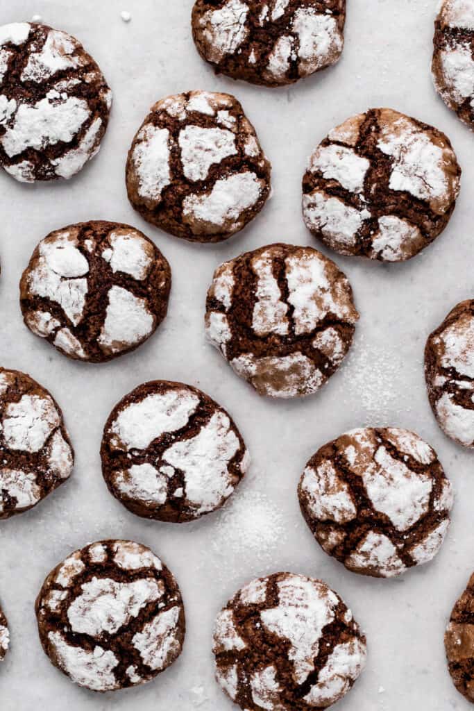 Gluten free chocolate crinkle cookies on a plate in a circle from a top view