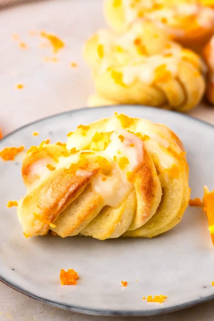 up close image of gluten free orange knots on a plate or orange zest on top