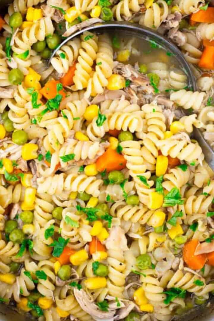 gluten free chicken noodle soup in a pot with a ladle