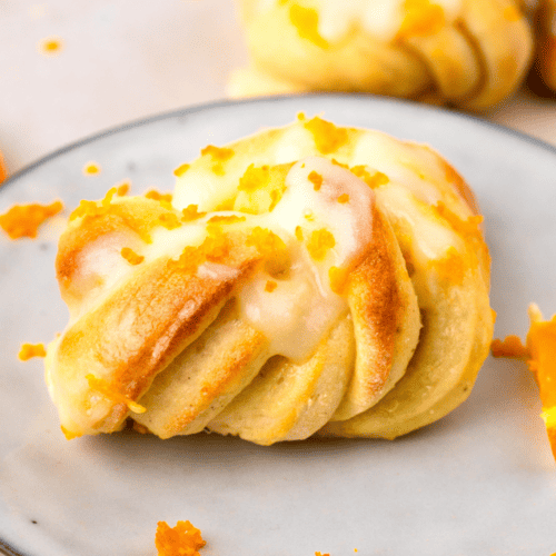 up close image of gluten free orange knots on a plate or orange zest on top