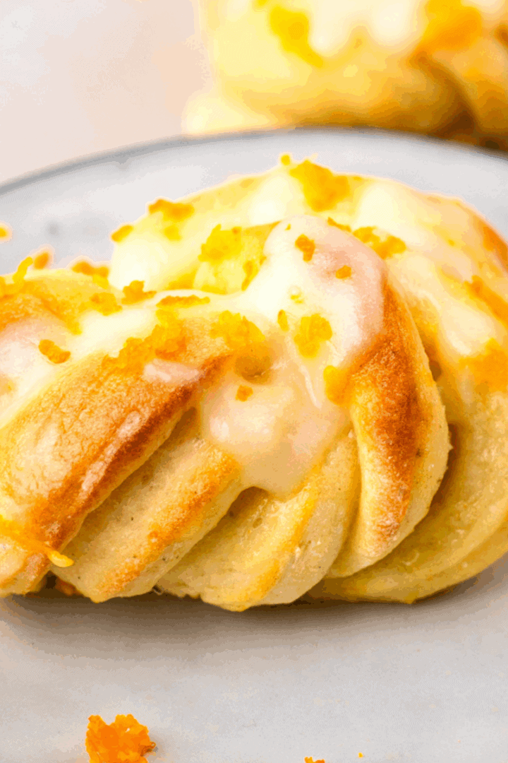 up close image of gluten free orange knots on a plate or orange zest on top