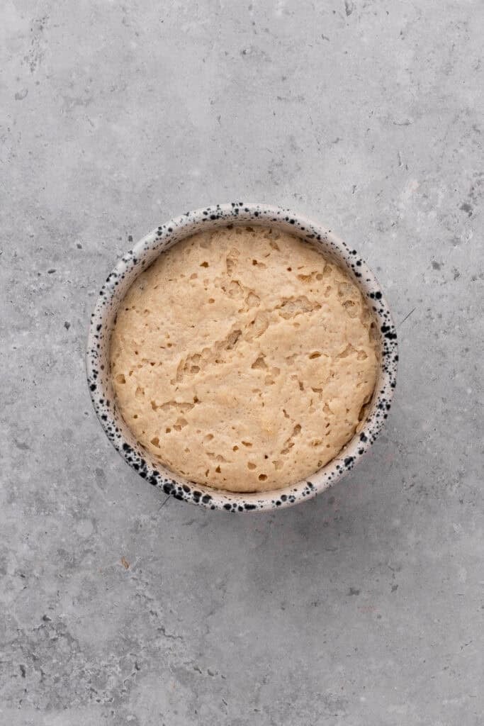 Chia seeds soaking in water in a bowl. Yeast, warm water and sugar blooming in a bowl.