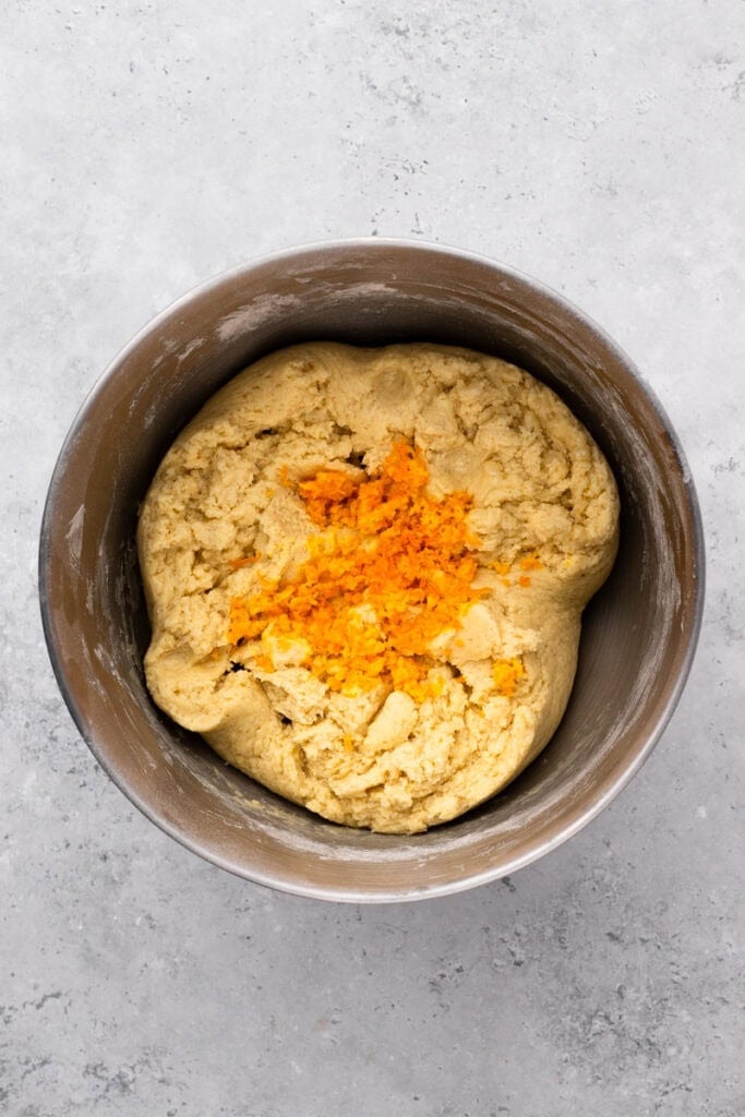 orange zest with dough in a bowl