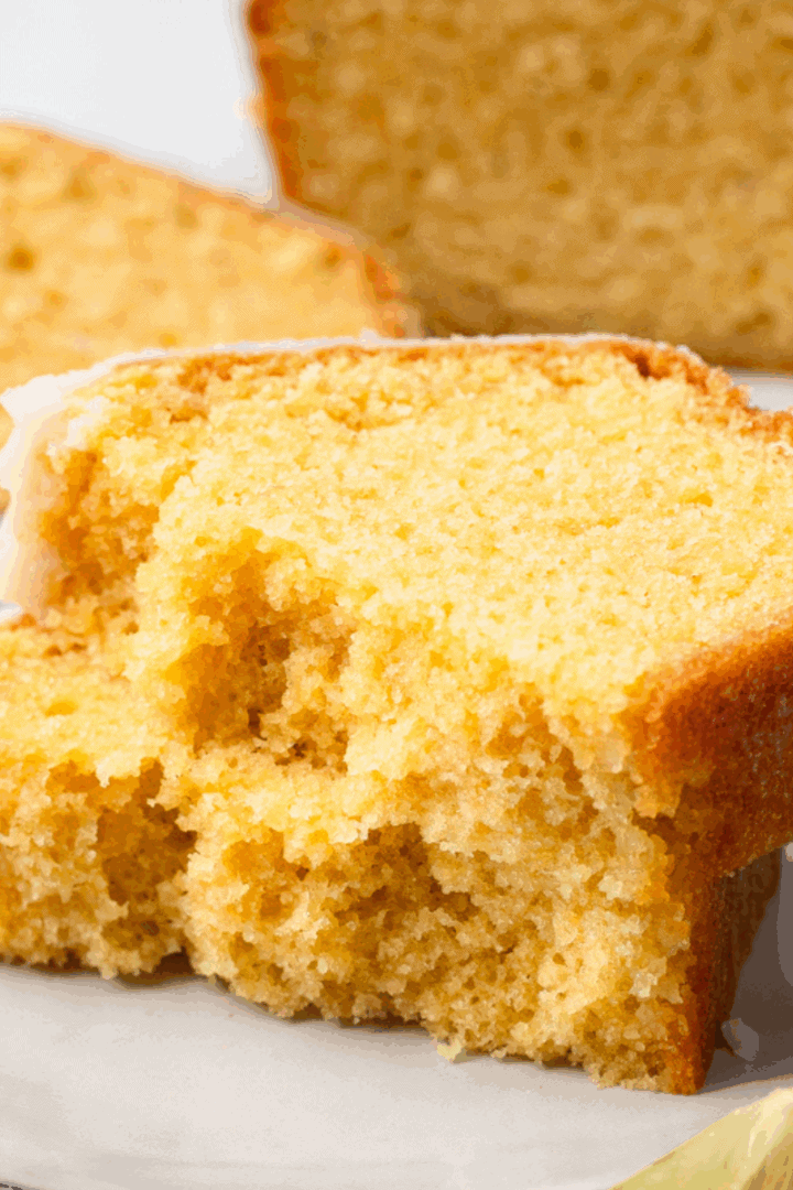 gluten free pound cake stacked on top of each other on white plate to show soft and buttery texture