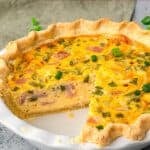 Easy Gluten Free Quiche in a pie pan with a slice taken out