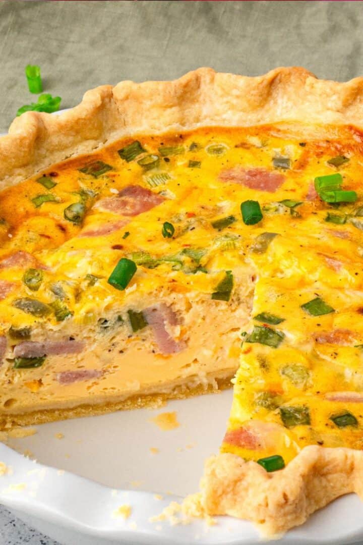 Easy Gluten Free Quiche in a pie pan with a slice taken out