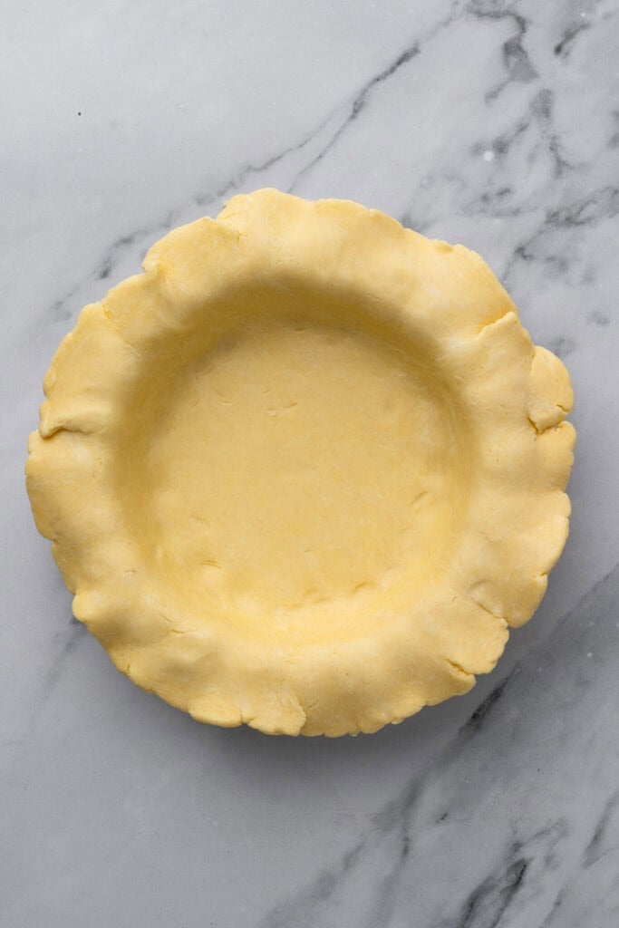 easy gluten free quiche unbaked pie crust in a pie pan