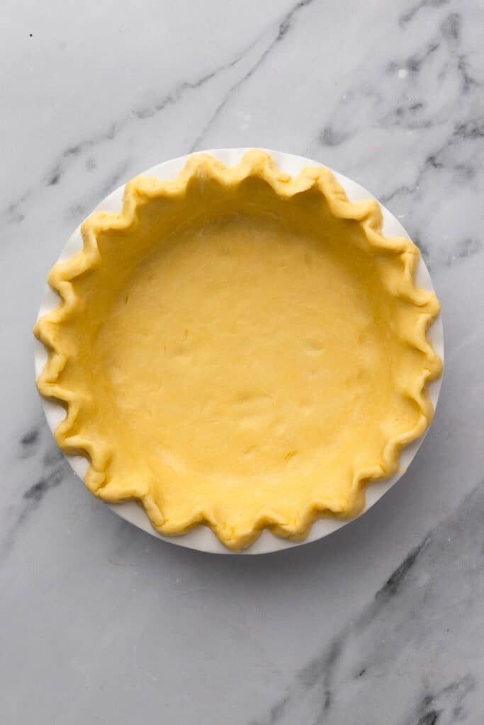 easy gluten free quiche unbaked pie crust in a pie pan