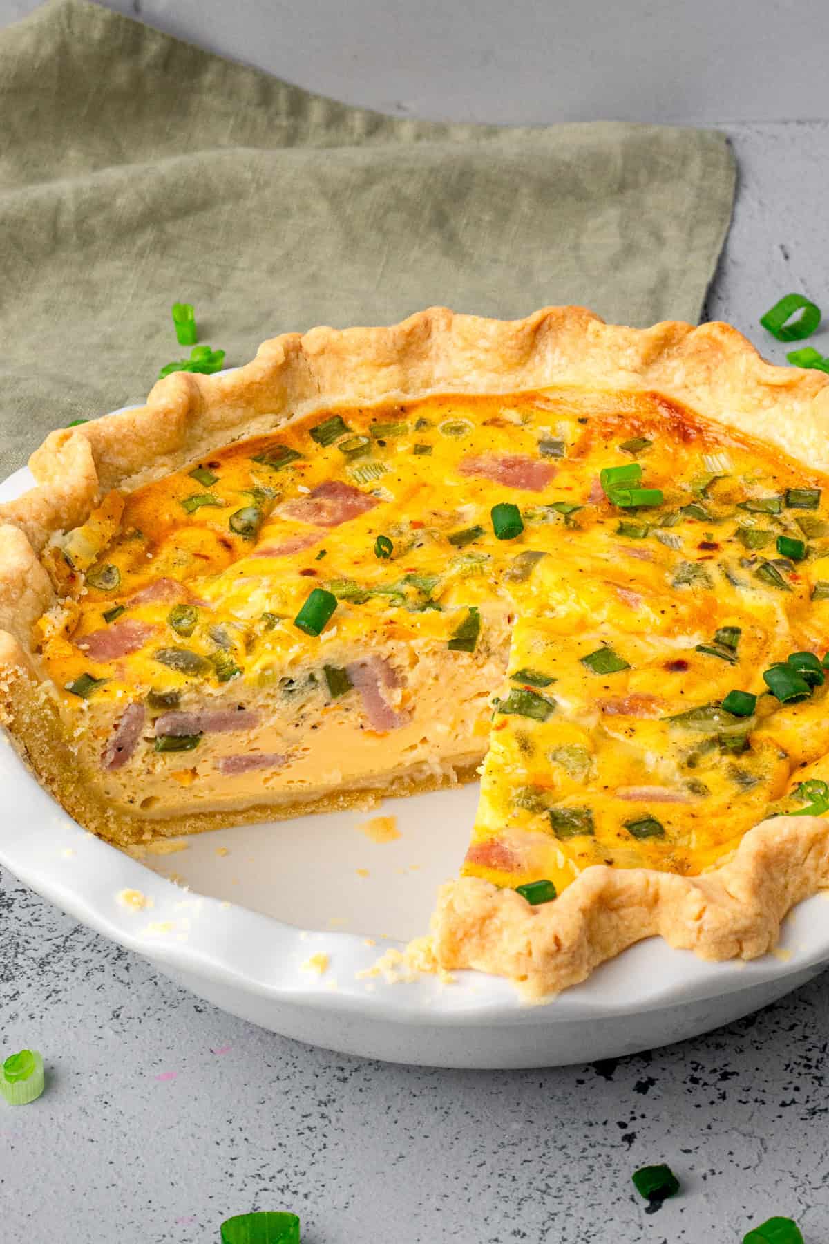 Easy Gluten Free Quiche in a pan with a slice taken out