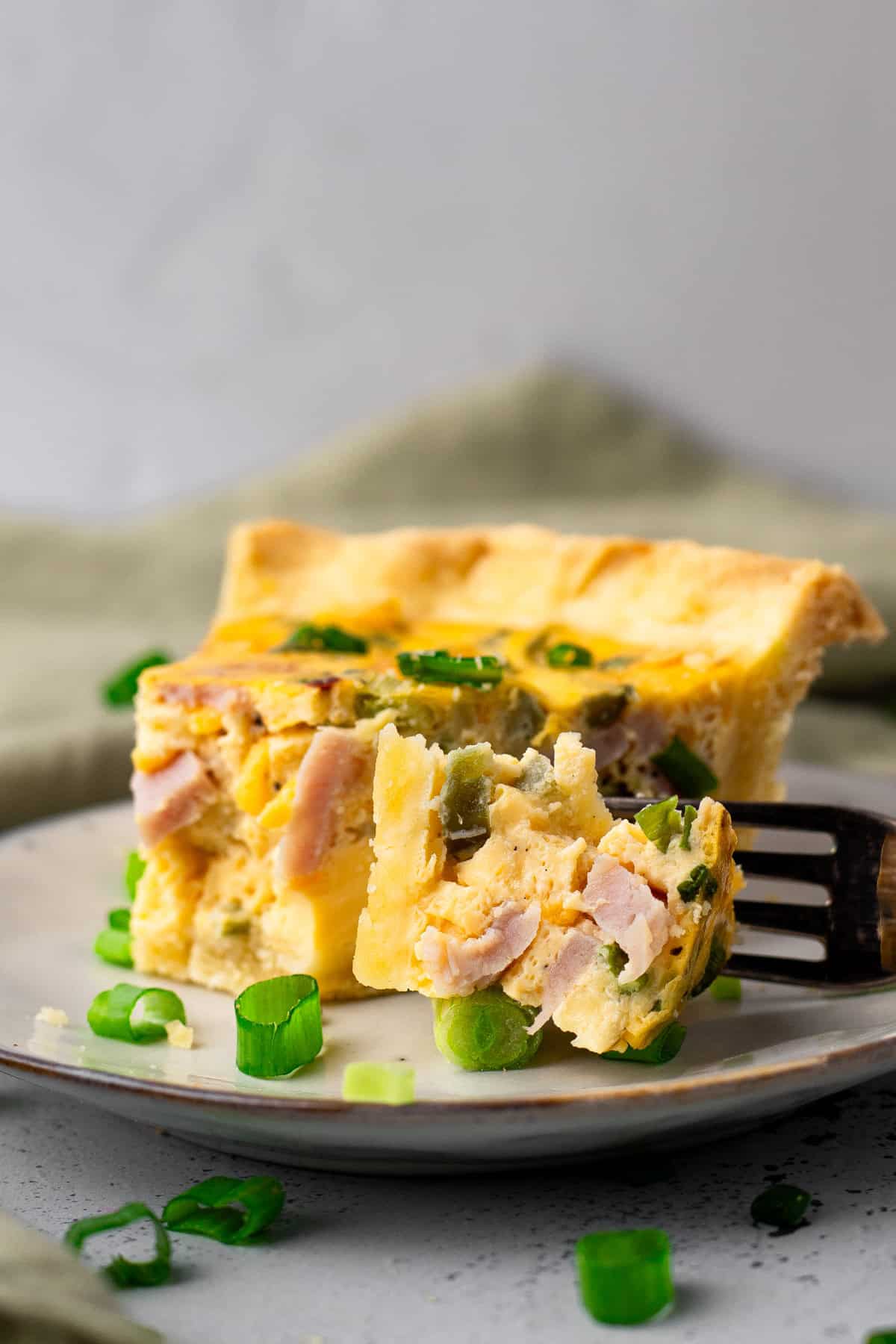 Easy Gluten Free Quiche on a plate with a bite taken out on a fork