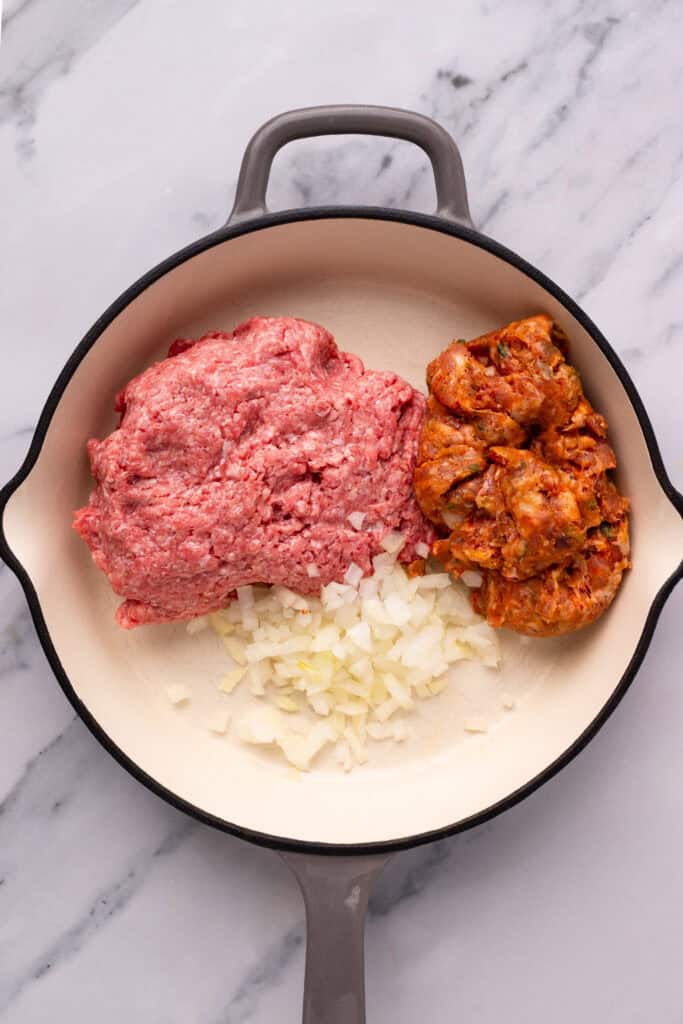 Homemade Gluten Free Lasagna sauce being prepared in a pan with meat and onion
