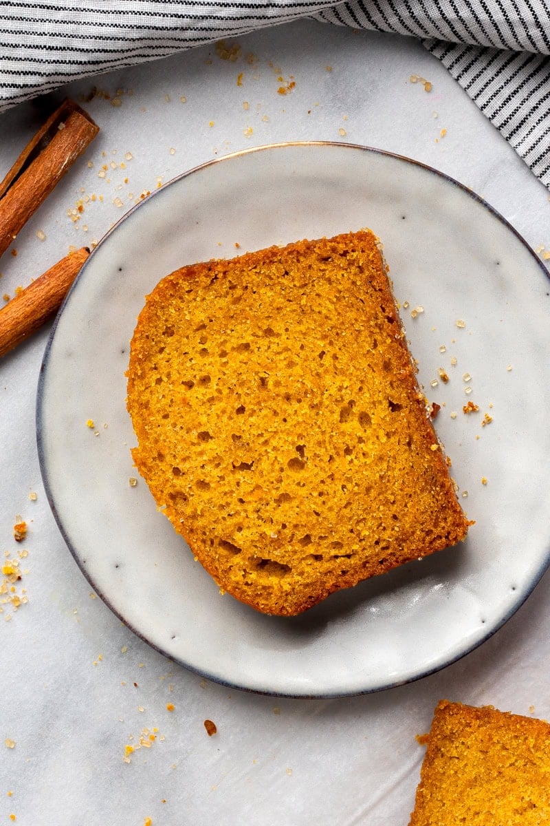 Super Soft Gluten Free Pumpkin Bread on a plate and showing the inside texture