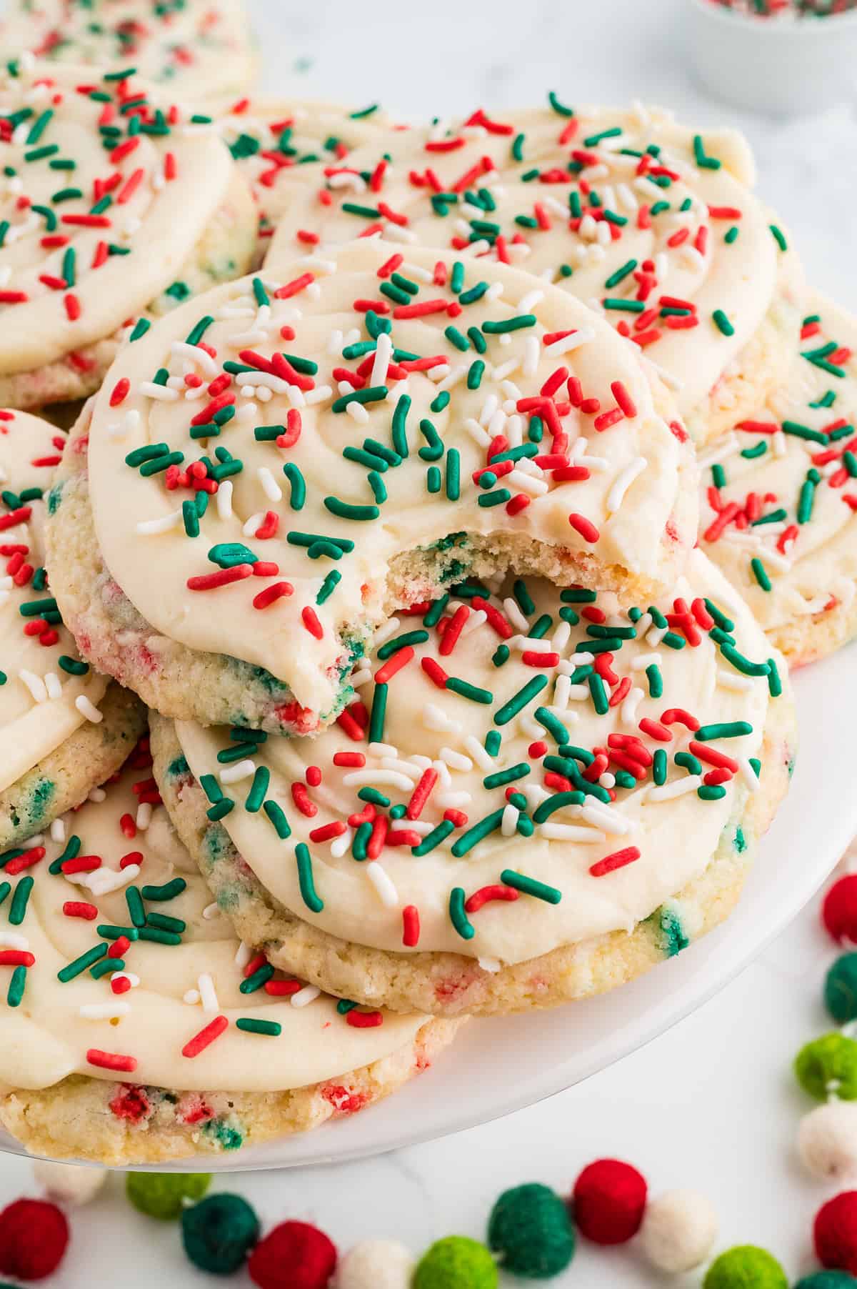 Christmas Crumbl Cookies Gluten Free stacked with sprinkles and bite taken out