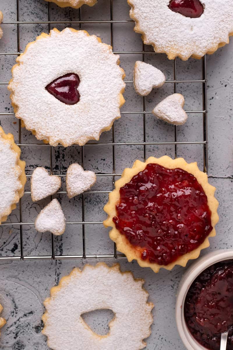 Easy Gluten Free Linzer Cookies on a wire baking wrap open and sandwiched