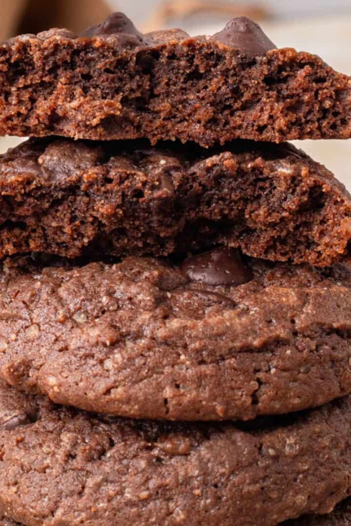The BEST Gluten Free Chocolate Cookie Recipe (Soft or Crunchy!) stacked on top of each other with a bite taken out.