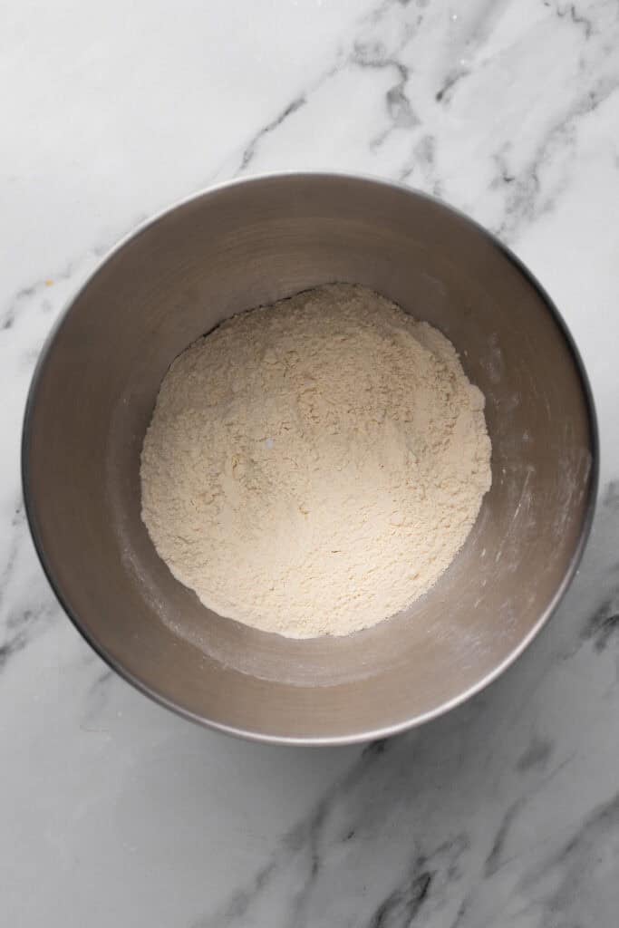 Gluten free dry ingredients for a cake in a silver bowl.