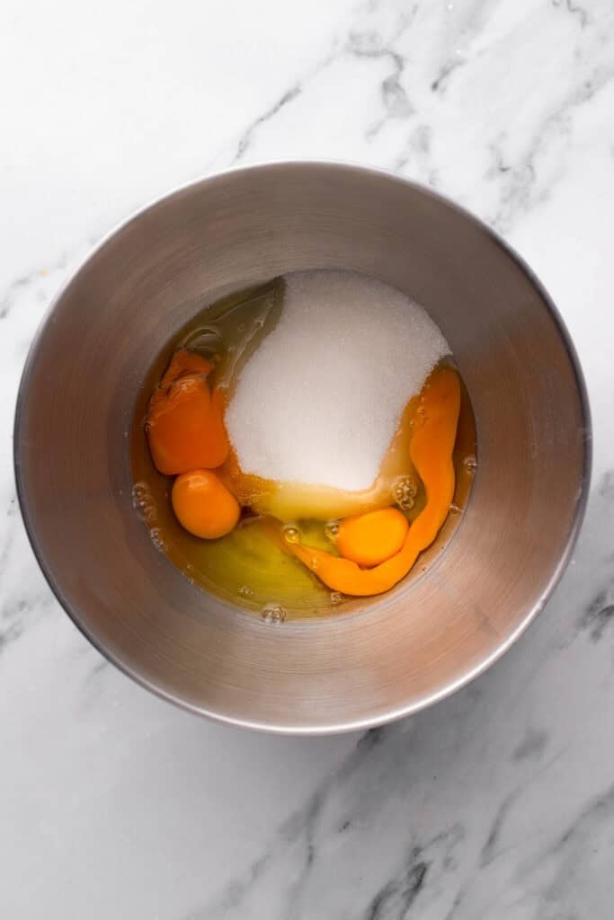 Eggs and sugar in a silver bowl.