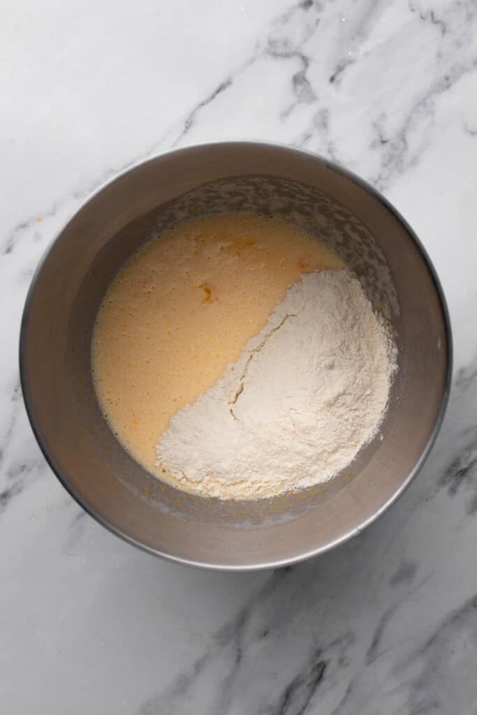 Chocolate cake batter in a silver bowl BEFORE chocolate is added so it is light in color.