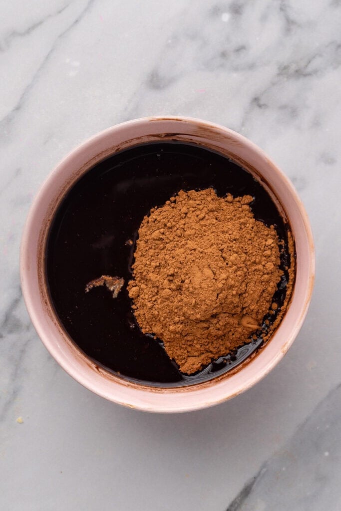 melted chocolate chips and cocoa powder in a pink bowl