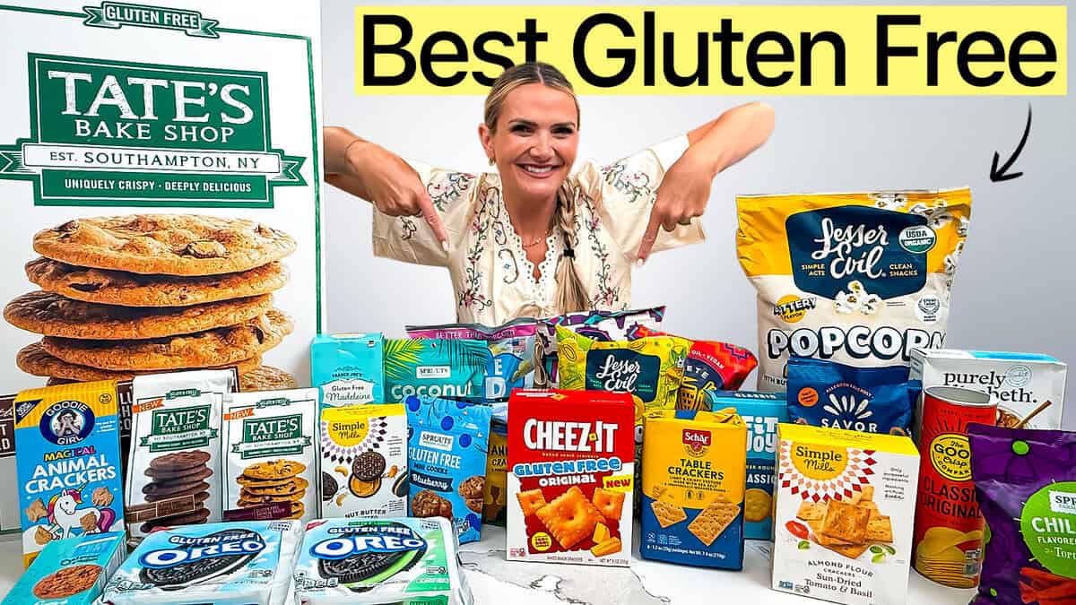 25+ gluten free snacks on a counter with a girl pointing to them